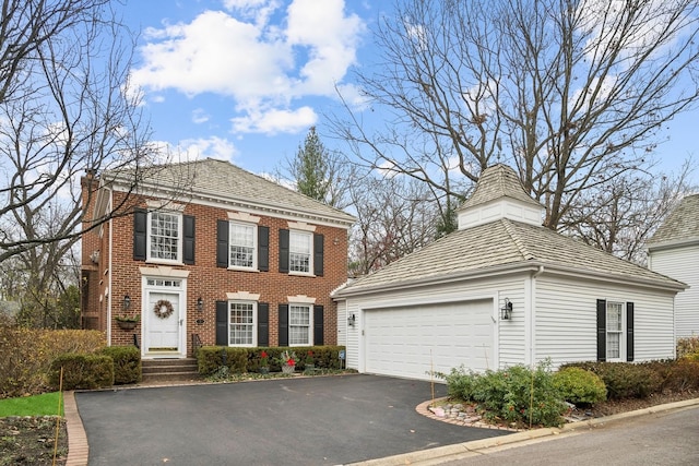 view of front of home with brick siding and aphalt driveway