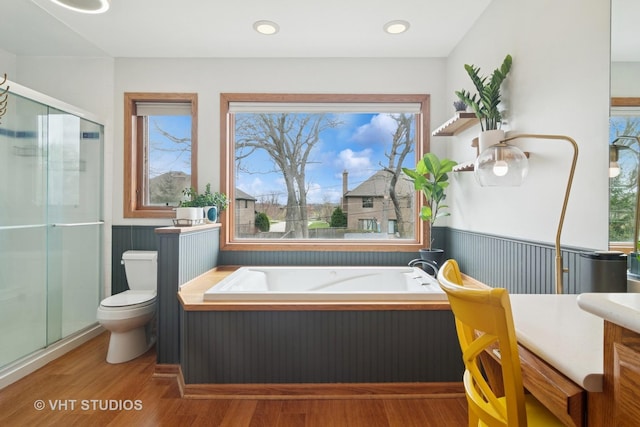 23114 W N Lakewood Ln, Lake Zurich, IL 60047 - bathroom featuring wood finished floors, a shower stall, toilet, a bath, and wainscoting