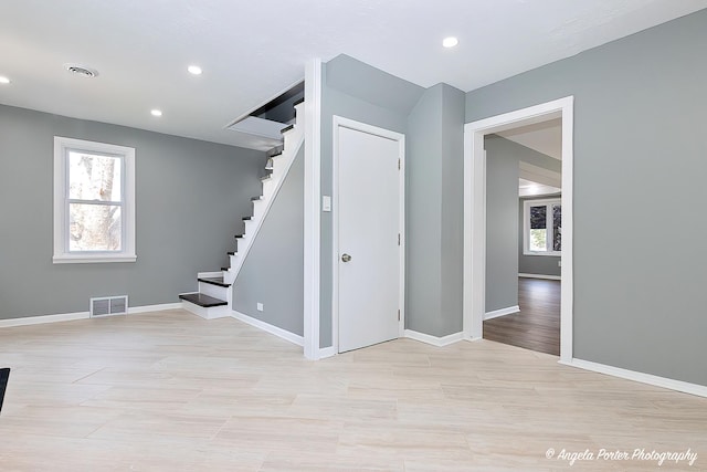 interior space with light wood-style floors, baseboards, recessed lighting, and visible vents