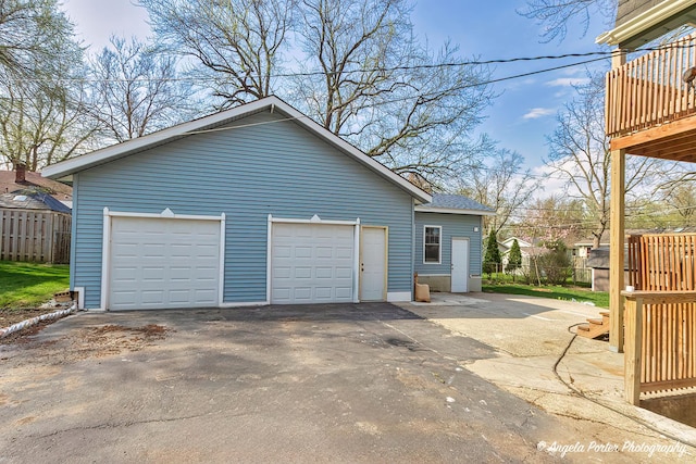 detached garage featuring fence
