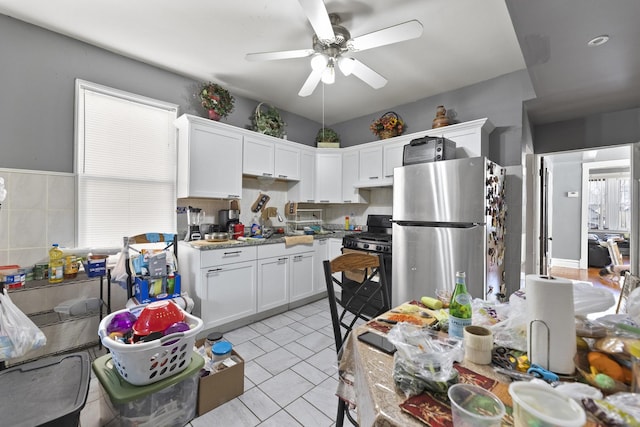 kitchen featuring white cabinets, light countertops, appliances with stainless steel finishes, and ceiling fan