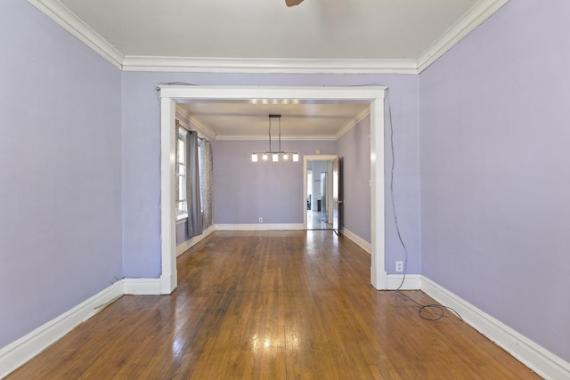 unfurnished dining area with wood-type flooring, baseboards, and crown molding
