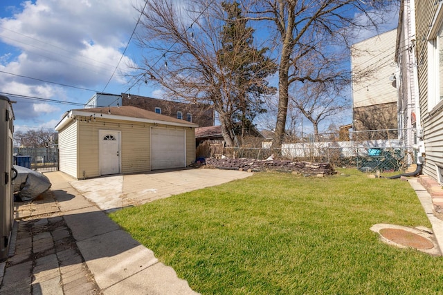 view of yard with driveway, fence, a garage, a patio area, and an outdoor structure
