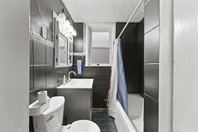 bathroom featuring a sink, a textured ceiling, toilet, shower / tub combo, and tile patterned flooring