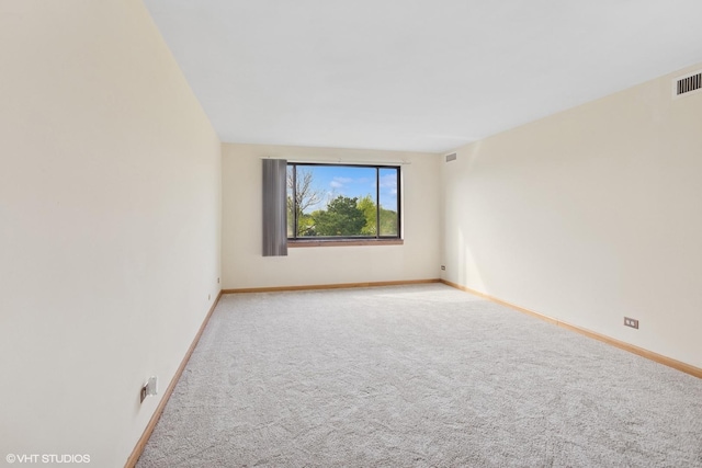 898 Wellington Ave Unit 310, Elk Grove Village, IL 60007 - spare room featuring light carpet and baseboards
