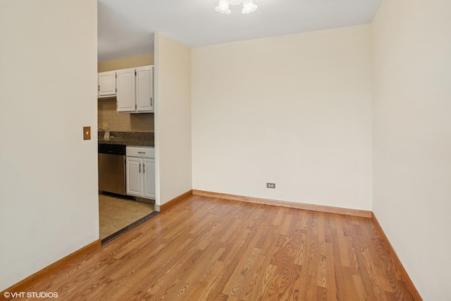898 Wellington Ave Unit 310, Elk Grove Village, IL 60007 - empty room with light wood finished floors, baseboards, and a chandelier