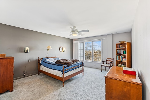 carpeted bedroom featuring baseboards and ceiling fan