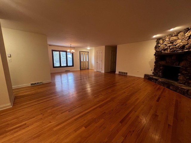 809 Overlook Dr, Frankfort, IL 60423 - unfurnished living room with wood finished floors, a chandelier, and a fireplace