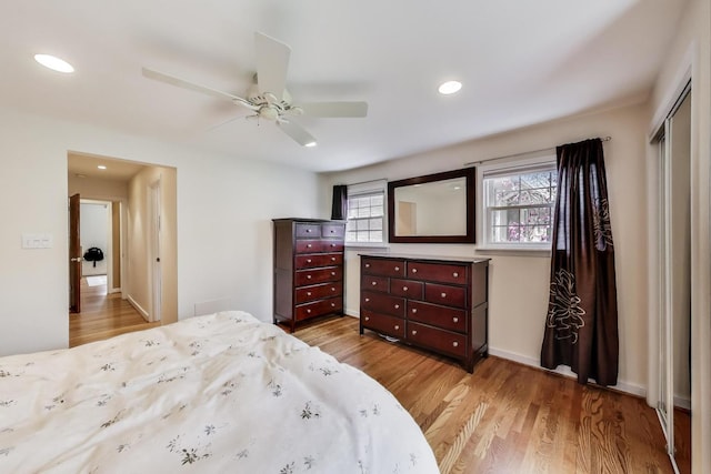 bedroom featuring recessed lighting, wood finished floors, and a closet