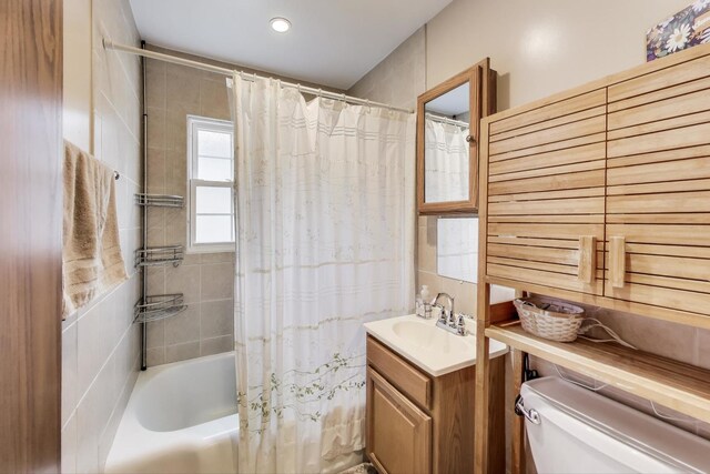 full bath featuring shower / bath combo, vanity, and toilet