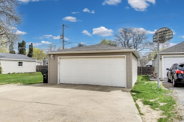 detached garage featuring fence
