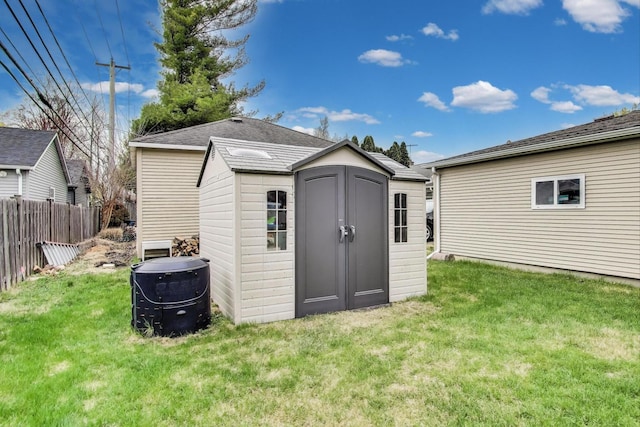 view of shed featuring fence