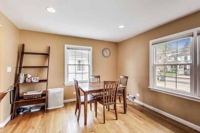 dining area featuring recessed lighting, a wealth of natural light, light wood finished floors, and baseboards