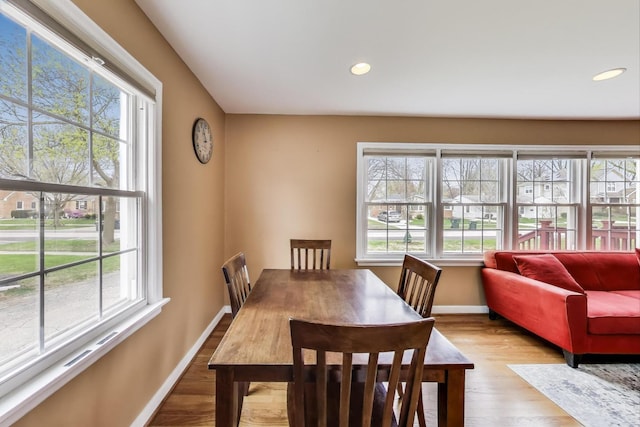 dining area featuring recessed lighting, wood finished floors, and baseboards