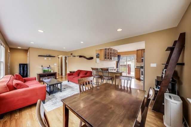 dining room with recessed lighting and light wood-type flooring