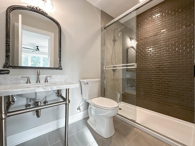 full bath with a shower stall, a sink, baseboards, toilet, and tile patterned flooring