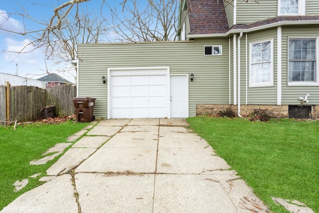 view of home's exterior with fence, a lawn, roof with shingles, and concrete driveway