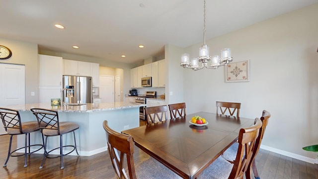 dining area featuring baseboards, an inviting chandelier, dark wood-type flooring, and recessed lighting