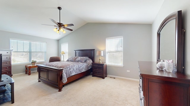 bedroom featuring lofted ceiling, light carpet, baseboards, and multiple windows