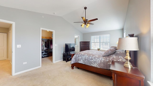 carpeted bedroom featuring baseboards, a spacious closet, lofted ceiling, a closet, and ceiling fan