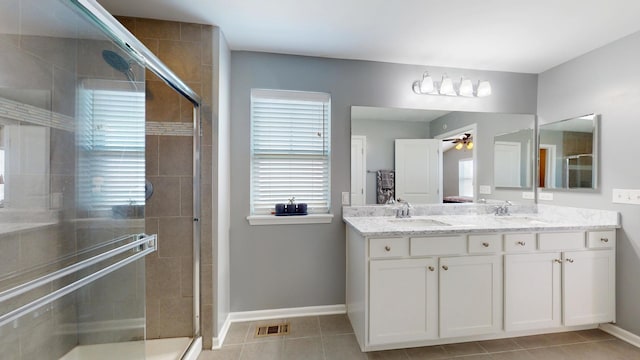 full bath featuring a ceiling fan, visible vents, a sink, and a stall shower