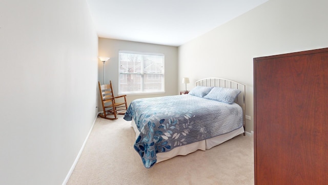 carpeted bedroom featuring baseboards