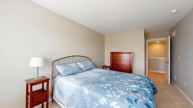 bedroom with visible vents, baseboards, and light colored carpet