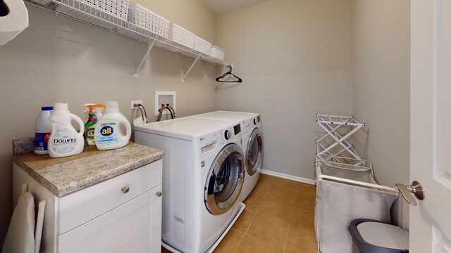 washroom featuring separate washer and dryer, baseboards, laundry area, and light tile patterned flooring