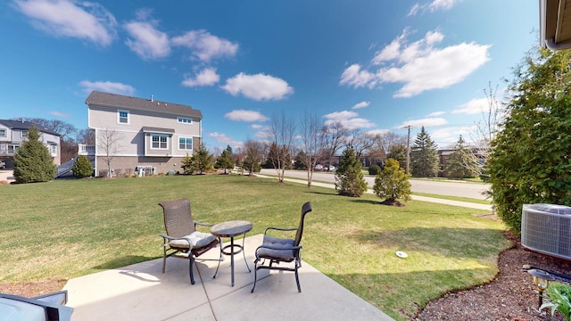 view of yard with cooling unit and a patio