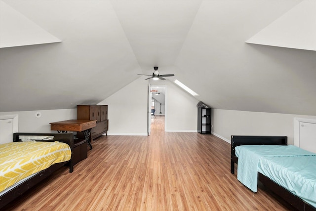 bedroom featuring ceiling fan, lofted ceiling, wood finished floors, and baseboards
