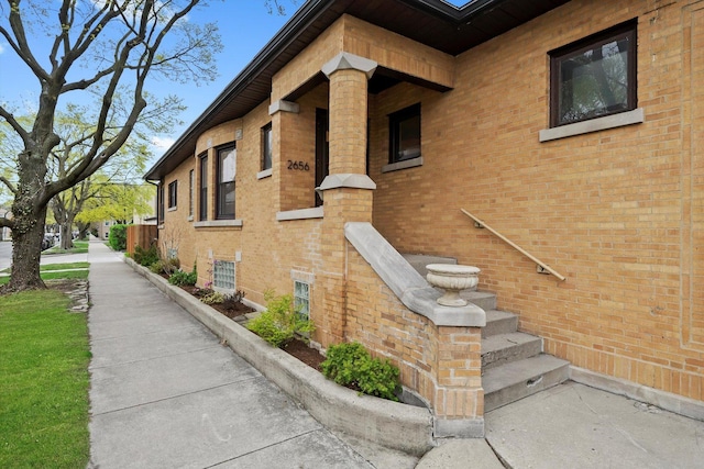 view of side of home with brick siding