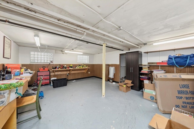 interior space with wainscoting and wooden walls