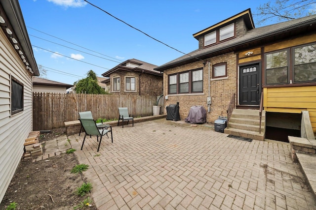view of patio featuring entry steps and fence