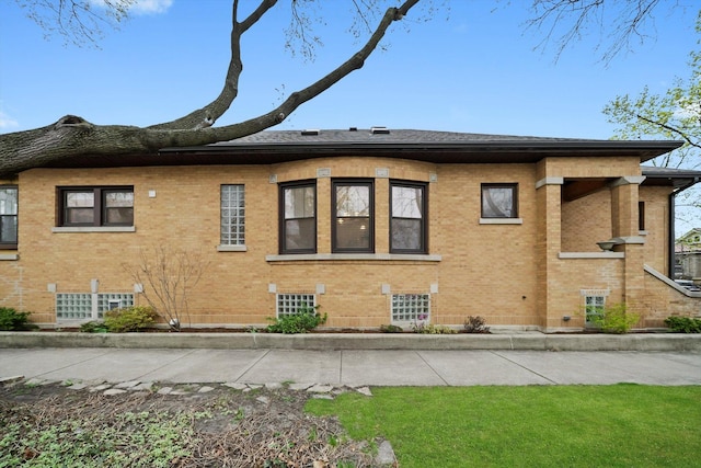 view of side of home featuring brick siding