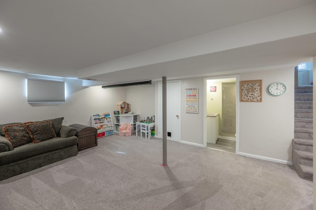 finished below grade area featuring stairs, carpet flooring, and baseboards