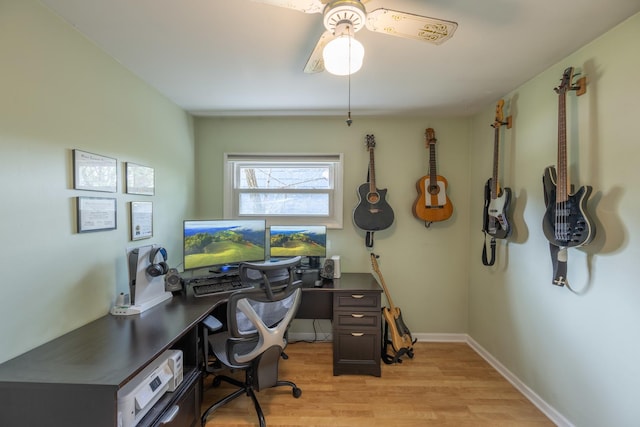office with light wood-type flooring and ceiling fan