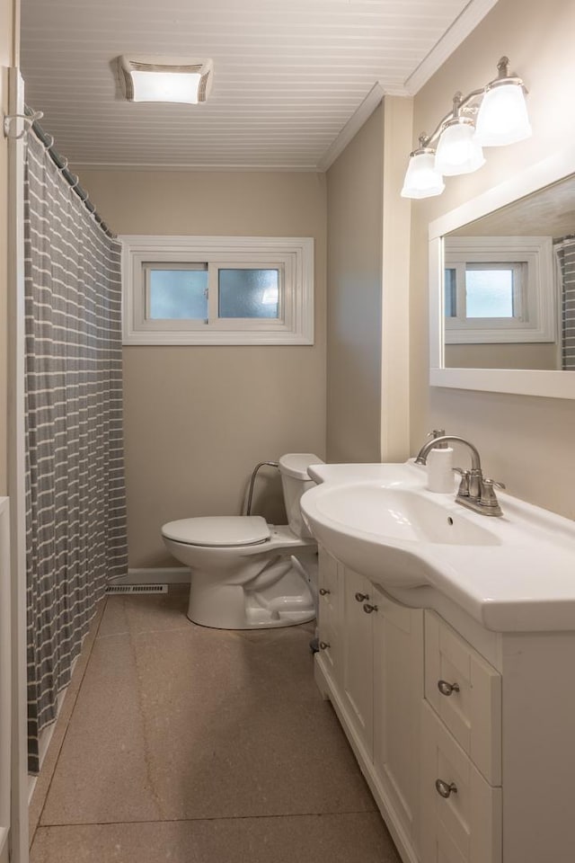 bathroom with toilet, crown molding, vanity, and a shower with shower curtain