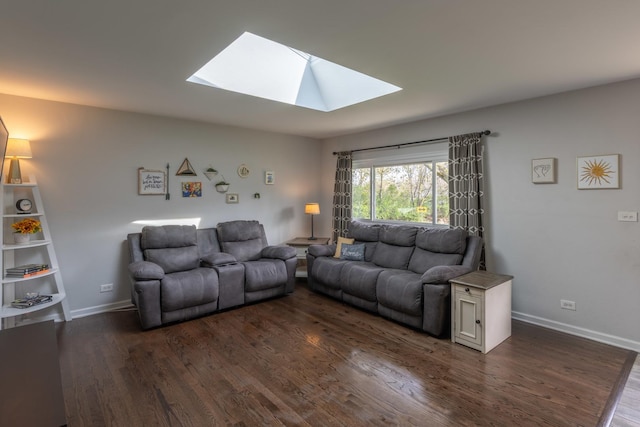 living room featuring dark wood finished floors, baseboards, and a skylight