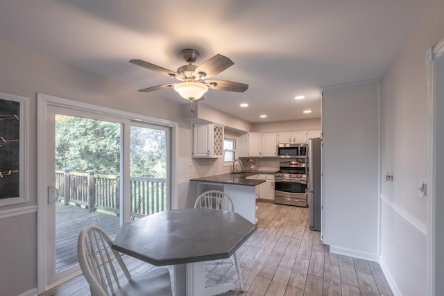 dining space with recessed lighting, a ceiling fan, and light wood-style floors