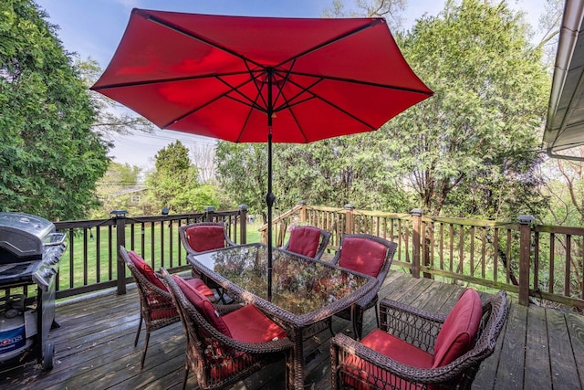 wooden deck featuring a yard, area for grilling, and outdoor dining space