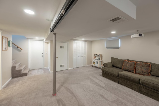 living area featuring visible vents, stairs, and carpet flooring