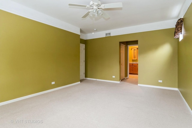 unfurnished room with light carpet, a ceiling fan, visible vents, and baseboards
