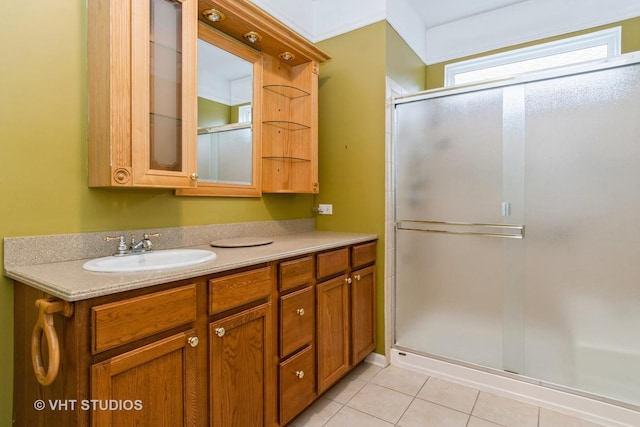 bathroom with a shower stall, tile patterned flooring, and vanity