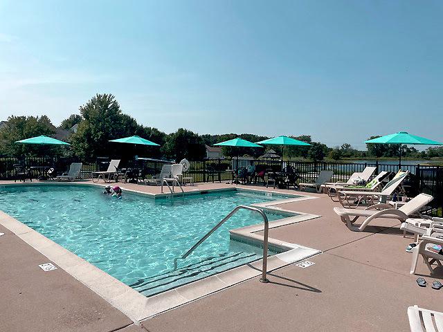 pool with a patio and fence
