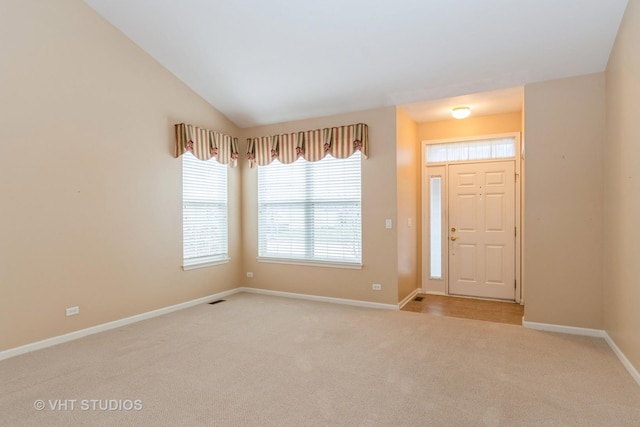 carpeted entryway featuring visible vents and baseboards