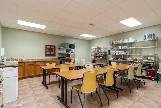 dining room with visible vents, a drop ceiling, and light tile patterned flooring