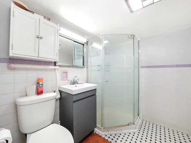 2758 N Newcastle Ave, Chicago, IL 60707 - bathroom with a shower stall, vanity, tile walls, toilet, and tile patterned flooring