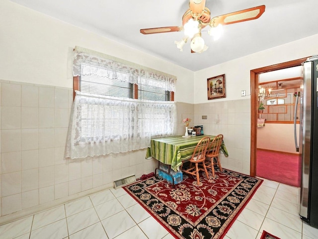 2758 N Newcastle Ave, Chicago, IL 60707 - dining area with wainscoting, light tile patterned flooring, tile walls, ceiling fan, and visible vents