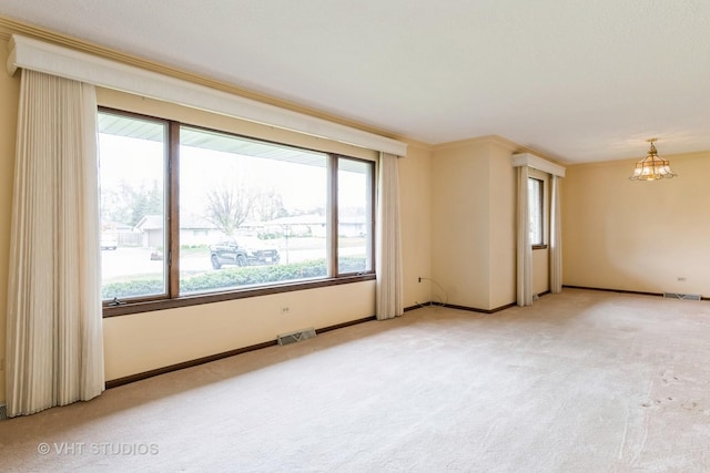 empty room with a notable chandelier, light colored carpet, baseboards, and visible vents