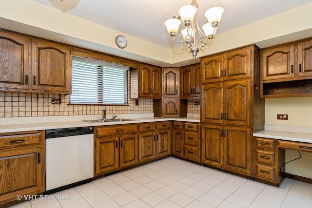 kitchen with a sink, dishwasher, brown cabinets, and light countertops
